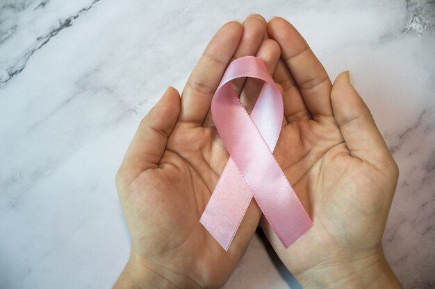 Pink October Hands holding pink ribbon