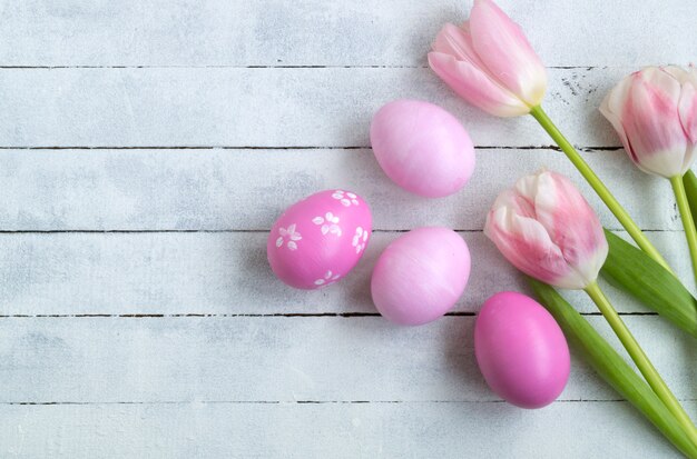 Pink painted Easter eggs on a wooden background