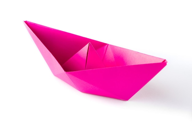 Pink paper boat origami isolated on a blank white background.