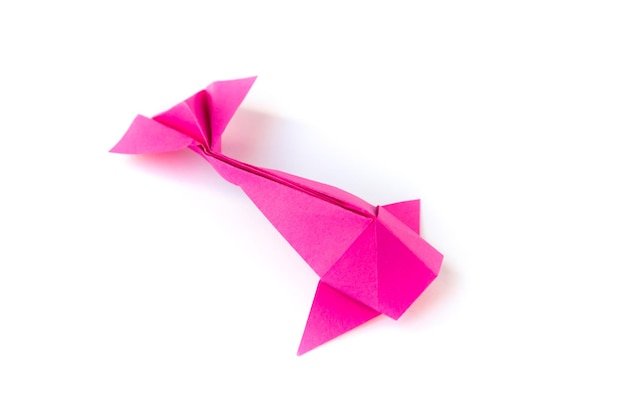 Pink paper fish origami isolated on a white background