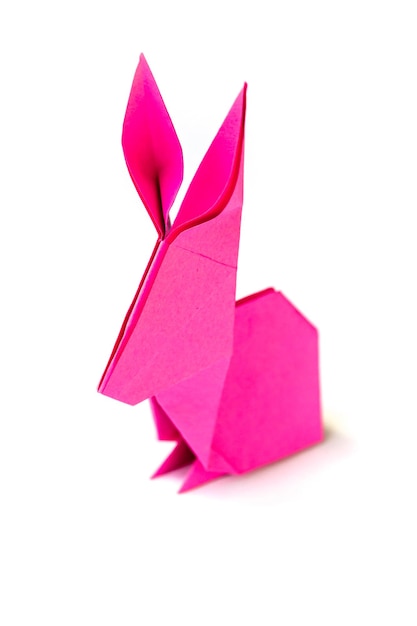 Pink paper rabbit origami isolated on a white background