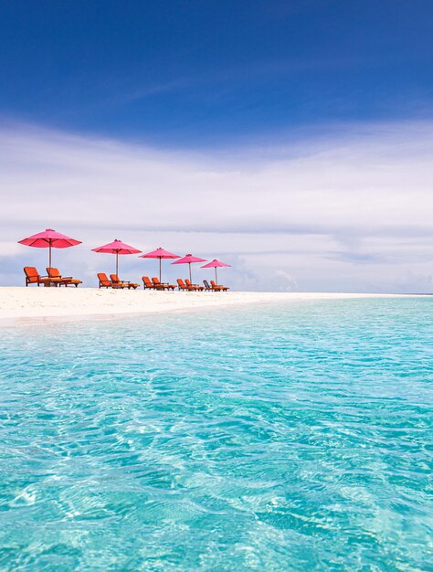 Pink parasol and chairs on tropical beach. amazing paradise island shore, white sand blue sea sky