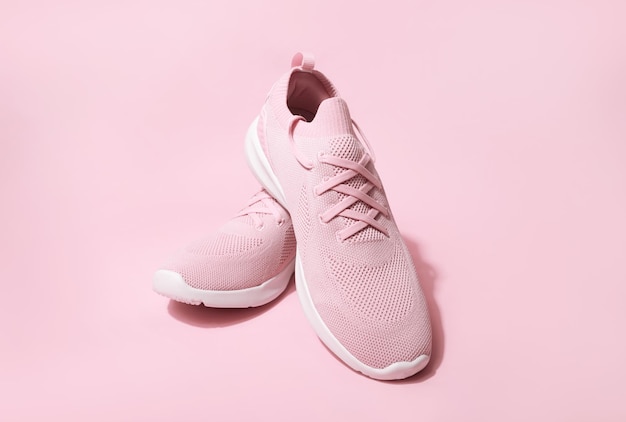 Pink pastel color sneakers on background