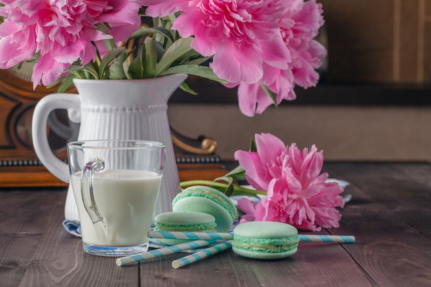 Pink peonies flower on dark wooden table