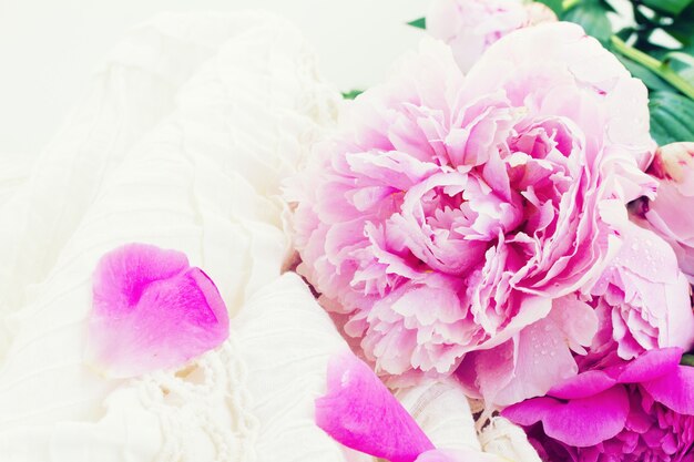 Pink peonies and white wedding dress, vintage style, toned