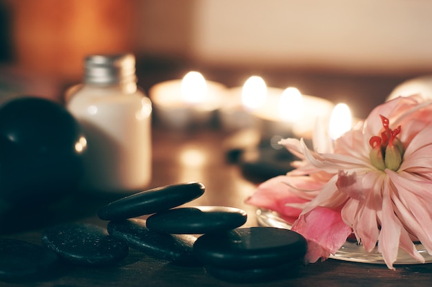 Pink peony flower and beautiful spa composition on wooden table