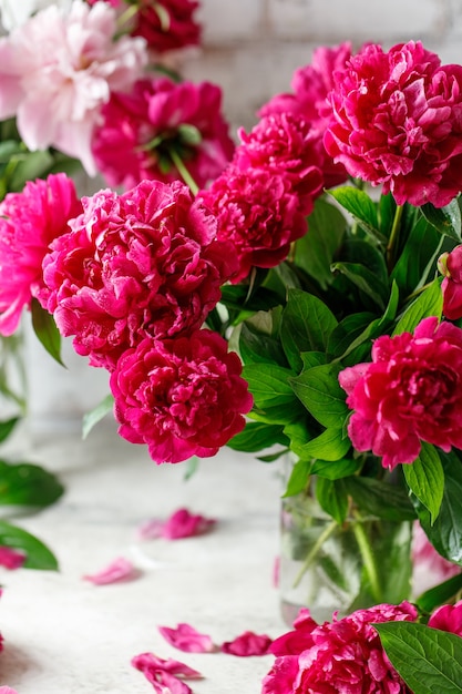 Pink peony flowers bouquet on rustic background