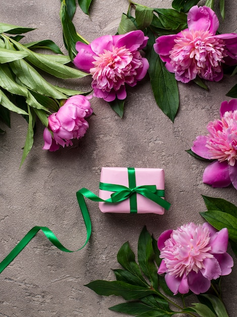 Pink peony flowers and gift box