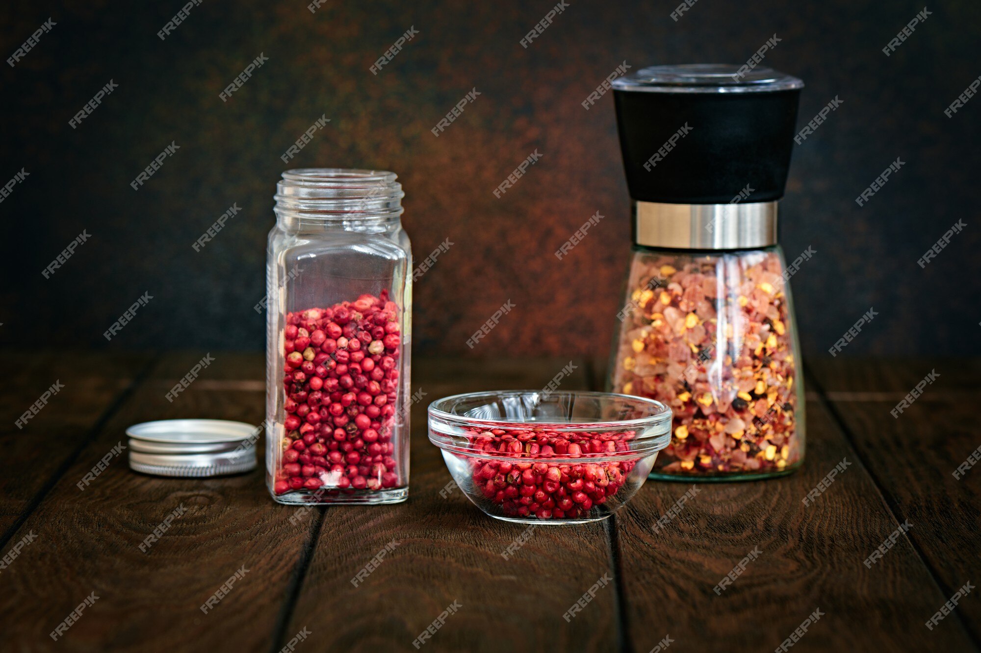 Premium Photo  Spices in glass jars on a pink background