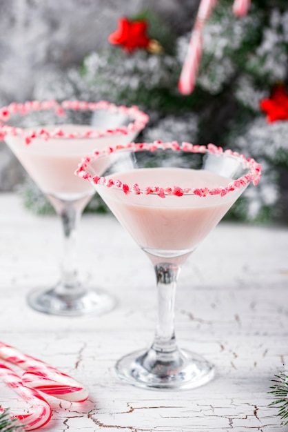 Pink peppermint martini with candy cane rim