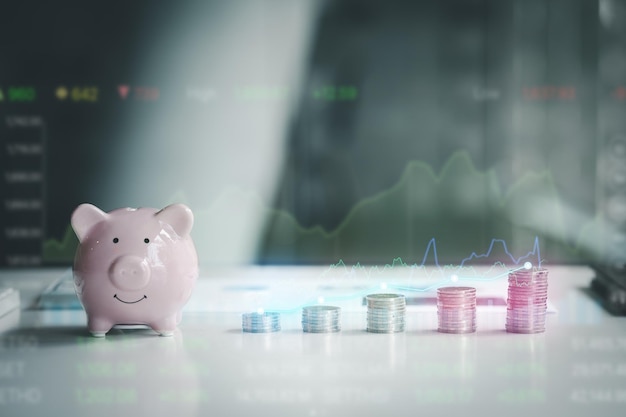 Pink pig piggy bank with silver coins stacks of coins stacked from low to high like growing money investing in stocks stock market chart graphics showing stock trading The idea of investing money