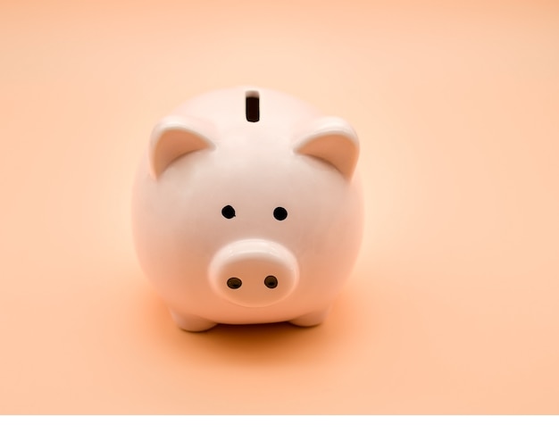 Pink piggy bank on a beige background. Money and business.