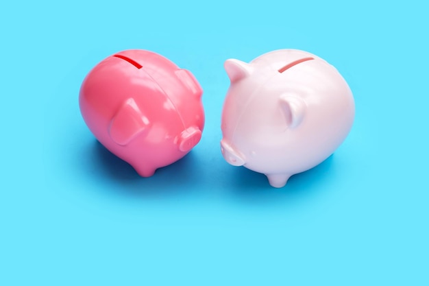 Pink piggy bank on blue background