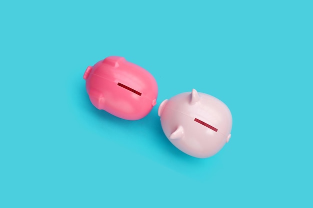 Pink piggy bank on blue background