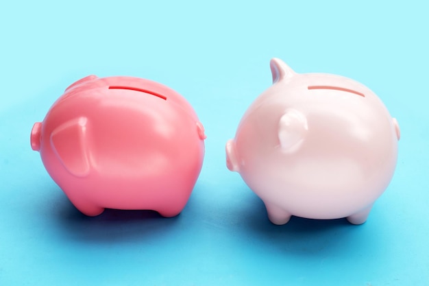 Pink piggy bank on blue background