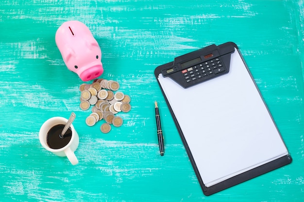 Photo pink piggy bank and chart  over coins stack, saving money concept.