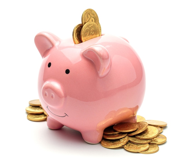 Pink piggy bank full of gold coins isolated on a white background Concept of where to invest your