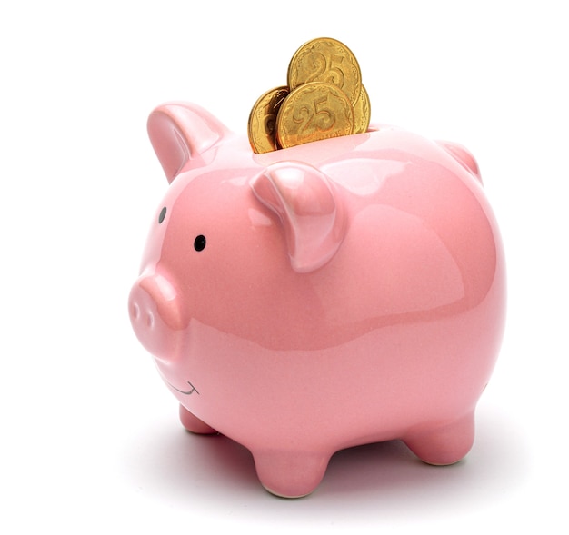 Pink piggy bank full of gold coins isolated on a white background Concept of where to invest your