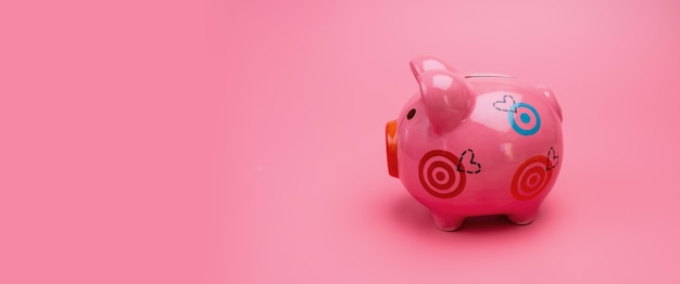 Pink piggy bank on pink