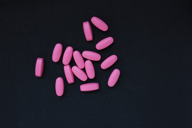 Pink pills on dark