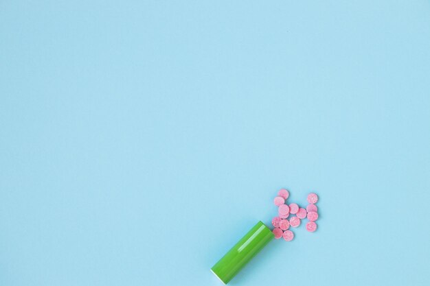 Pink pills isolated on blue background