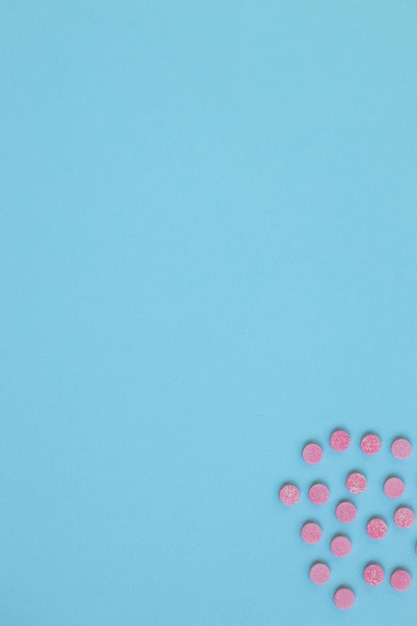 Pink pills isolated on blue background