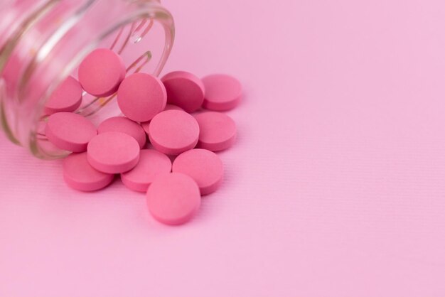 Pink pills on a pink background