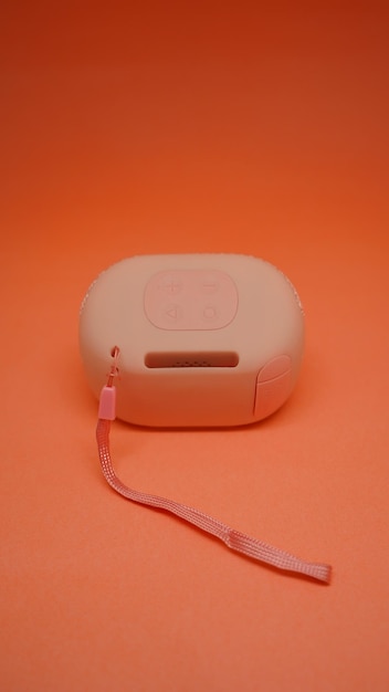 A pink plastic device with a red cord that says " i'm a robot " on it.