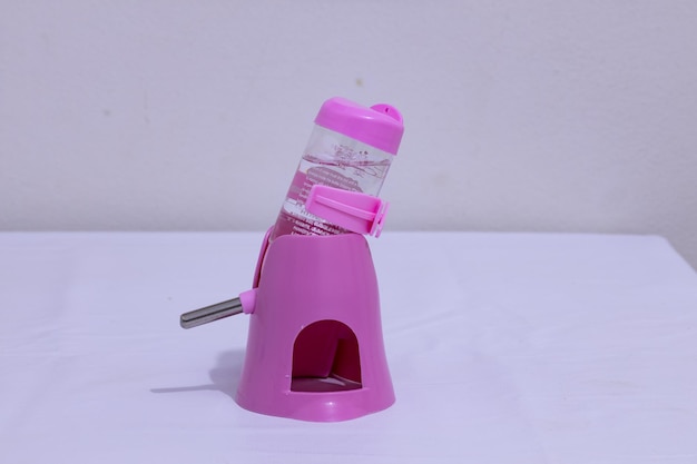 Pink plastic hamster drinking bowl and feeding bowl