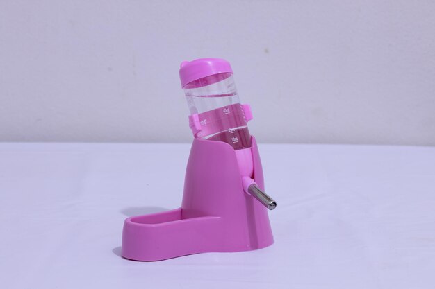 Pink plastic hamster drinking bowl and feeding bowl