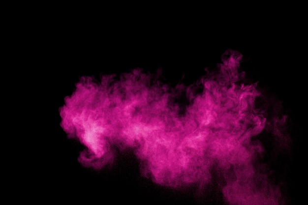 Pink powder explosion on black background.