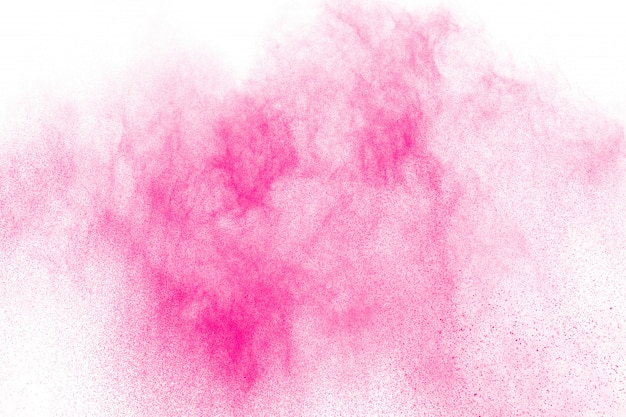 Photo pink powder explosion on white background.pink dust splash cloud on background.