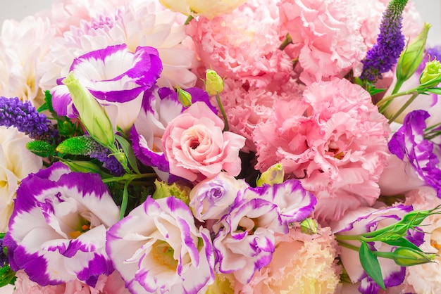 Pink and purple bouquet of flowers in a pink box isolated