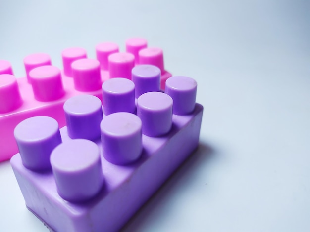 Pink and purple lego blocks on white background