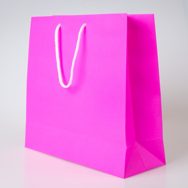 Pink or purple shopping bag one white background and copy space for plain text or product