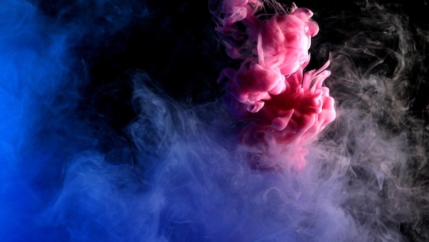 Pink and purple smoke floating in a dark background