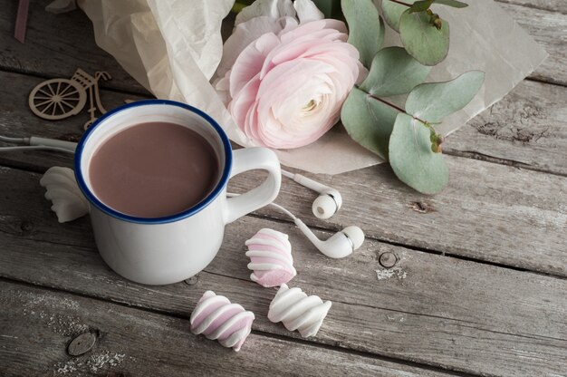 Pink ranunculus, headphones, hot chocolate 