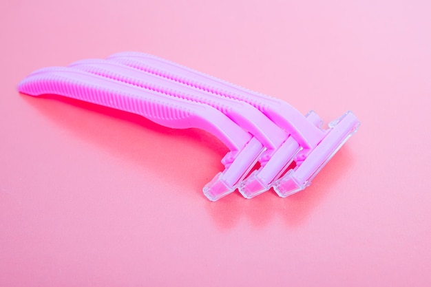 Pink razor on a pink background closeup