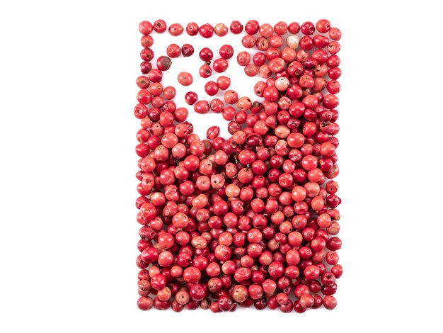 Pink and red peppercorns isolated on white background with copy space for text or images spices and