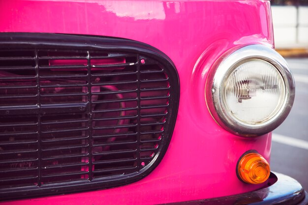 Pink retro car with round headlights