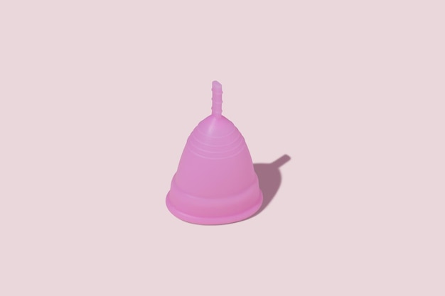 Photo pink reusable silicone menstrual cup concept of feminine hygiene gynecology and health