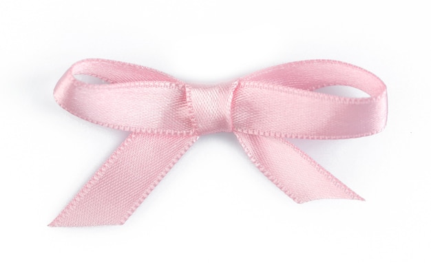 Pink ribbon bow isolated on white surface