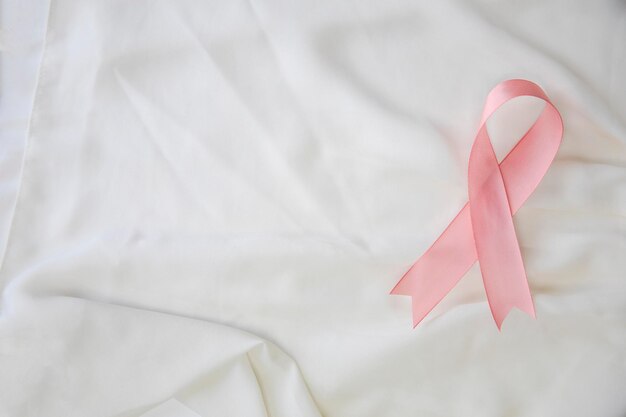 Pink ribbon breast cancer awareness health medical concept satin background