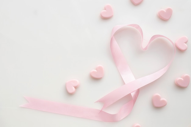 Pink ribbon heart shape on isolated white background