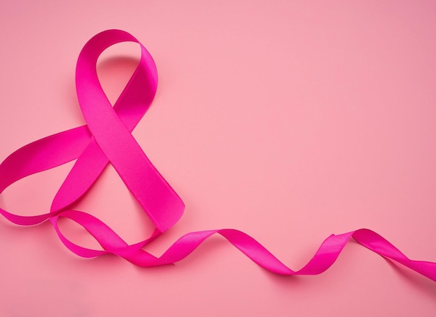 Pink ribbon on pink background