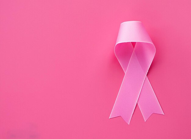 Photo pink ribbon on pink background