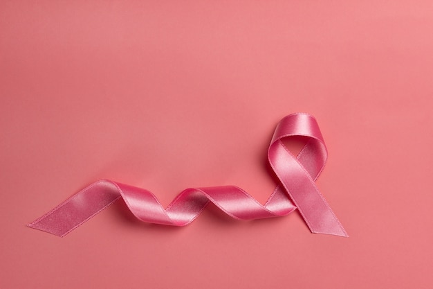 Pink ribbon on a rose background