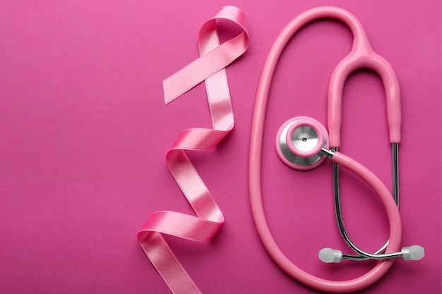 Pink Ribbon and Stethoscope on Color Background Breast Cancer Awareness Concept