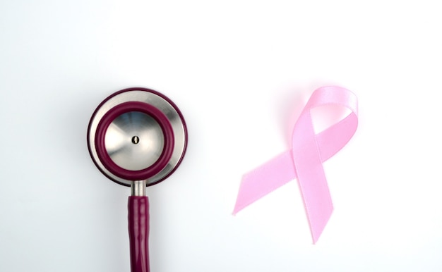 Stetoscopio nastro rosa su sfondo bianco simbolo di consapevolezza del cancro al seno