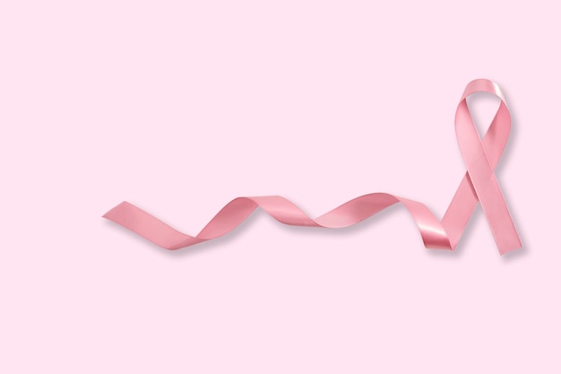 Pink ribbon symbol Breast Cancer Awareness on pink background